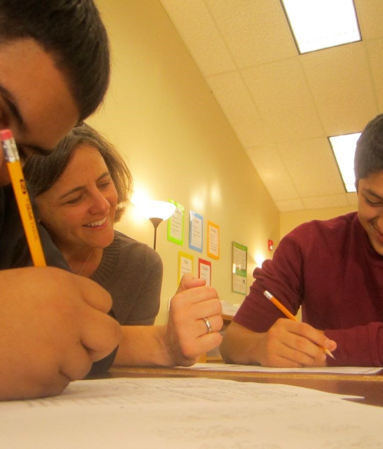 A volunteer working with a student in math class.